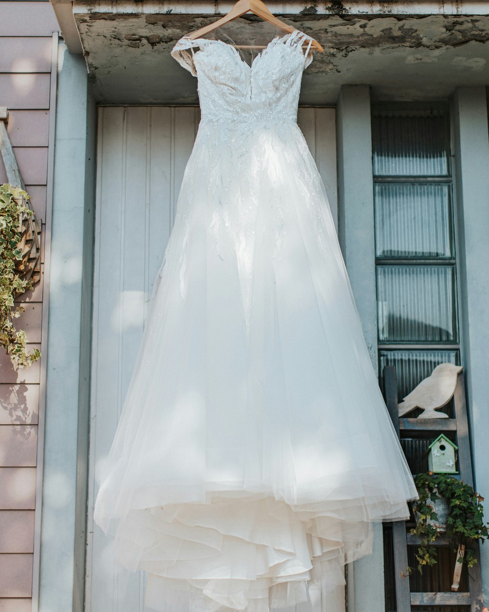 Wedding gown hanging on a wooden hanger