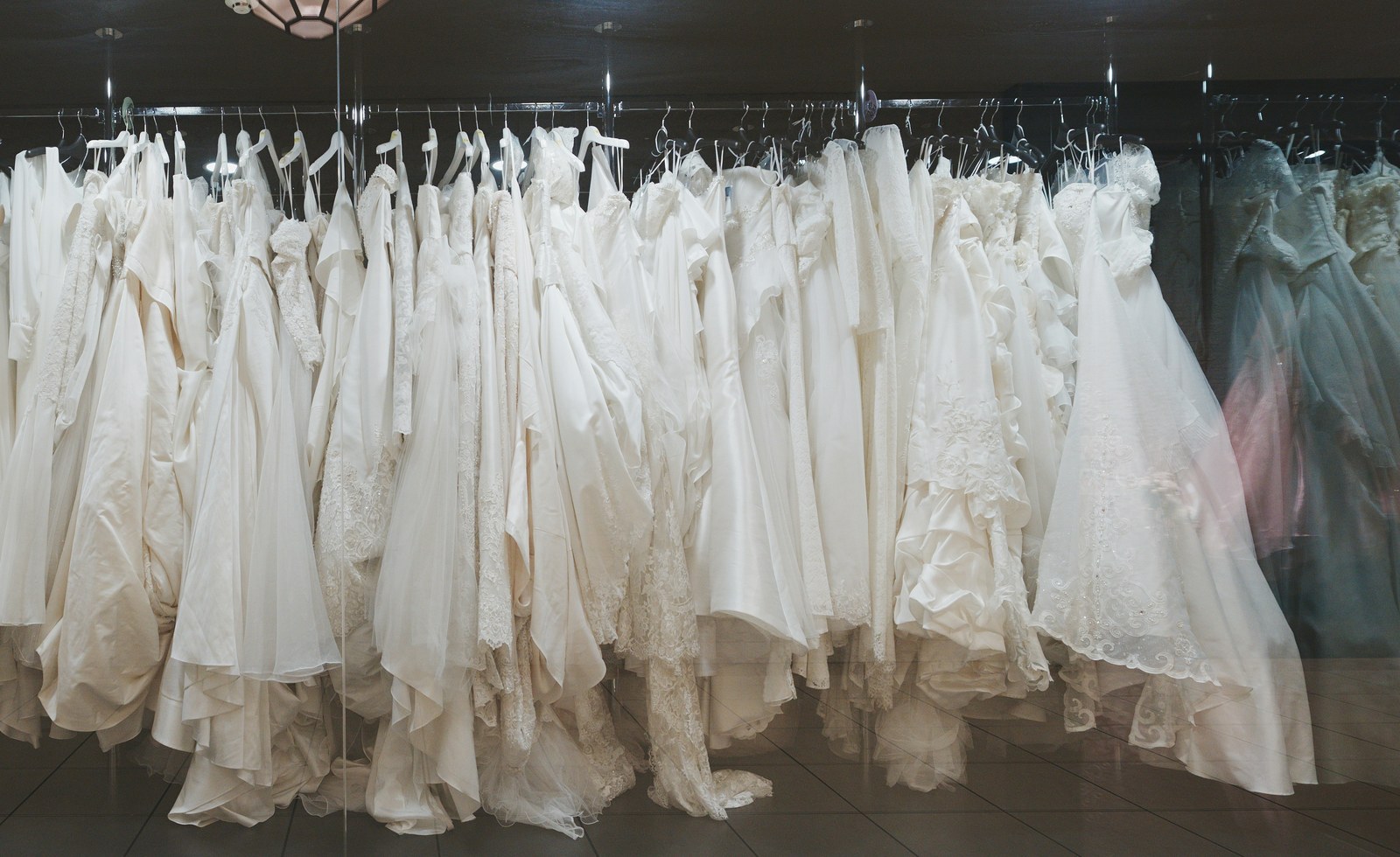Curated rack of wedding gowns in a boutique setting
