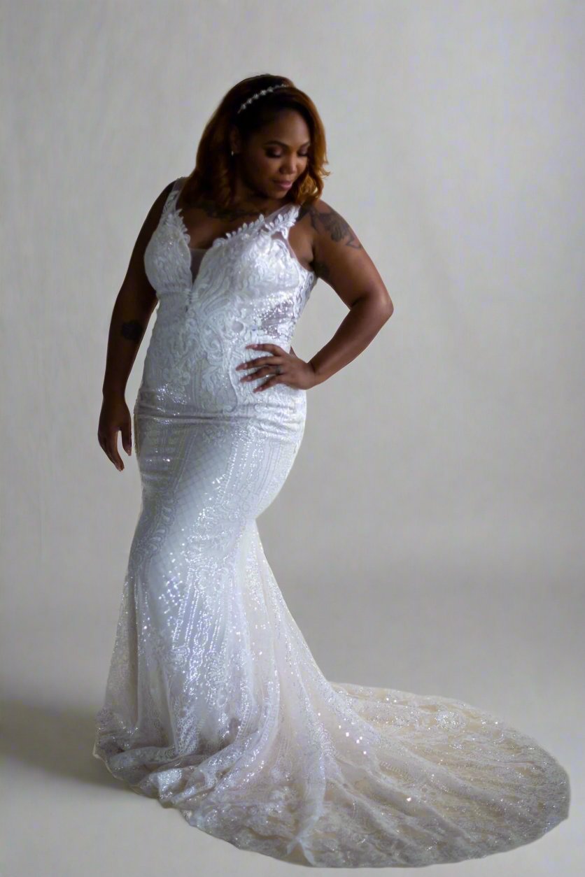 Model wearing a white Randy Fenoli Bride wedding dress, Basia, in front of natural peach photoshoot backdrop.