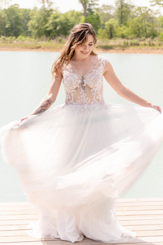 Model on a dock wearing discontinued Randy Fenoli dress, Rose, in size 6